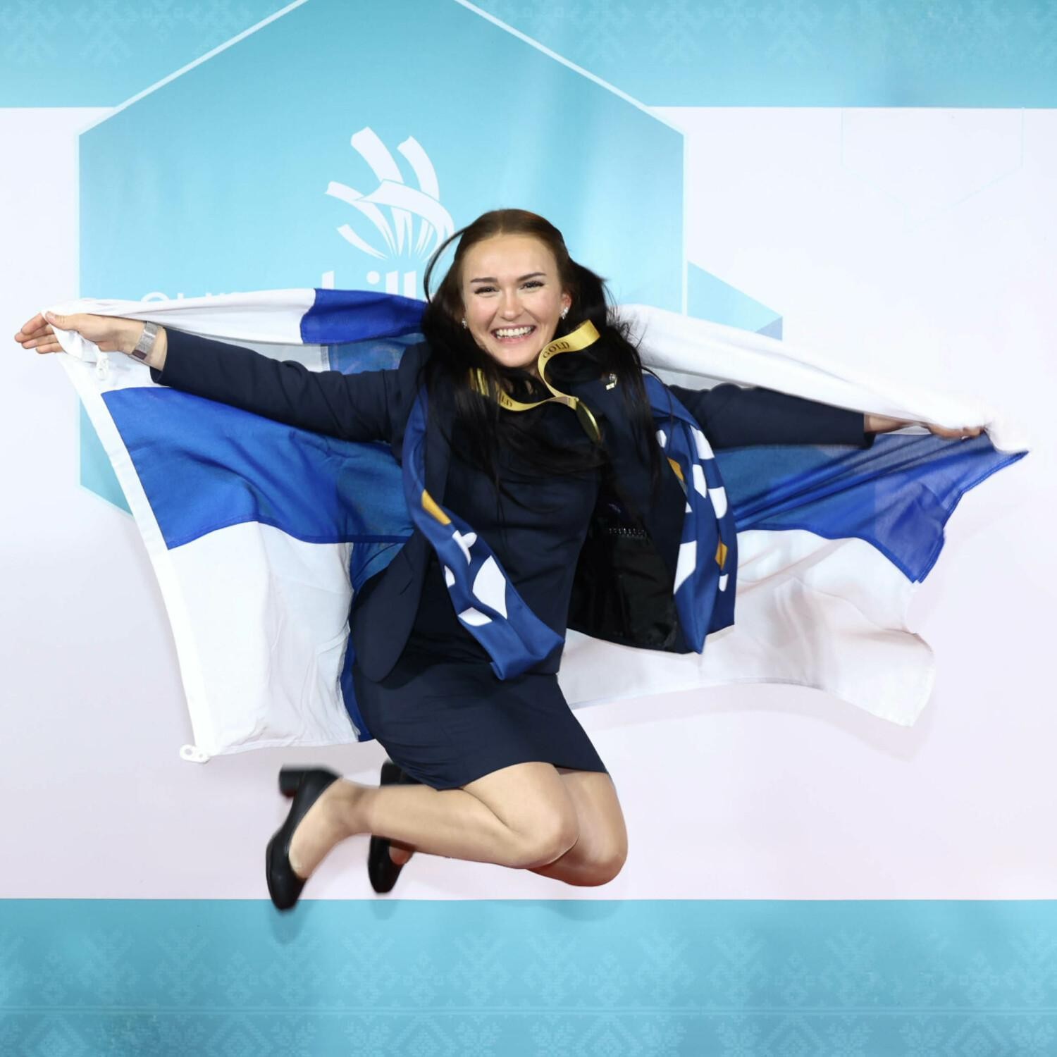 The Skills winner jumps into the air with the Finnish flag.